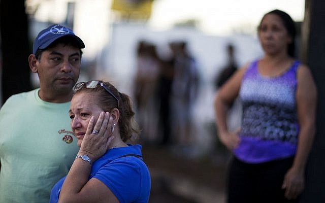 Carmen Feldman, of Orlando, right, cries while visiting for the first the scene of the Pulse nightclub mass shooting from a block away with Jose Garcia, left, Friday, June 17, 2016, in Orlando, Fla. (AP/David Goldman) Carmen Feldman, of Orlando, right, cries while visiting for the first the scene of the Pulse nightclub mass shooting from a block away with Jose Garcia, left, Friday, June 17, 2016, in Orlando, Fla. (AP/David Goldman)