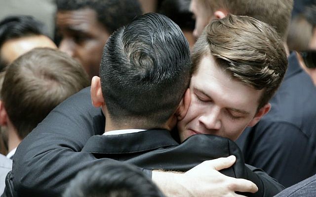 Mourners embrace following the funeral service for Christopher Andrew Leinonen, one of the victims of the Pulse nightclub mass shooting, outside the Cathedral Church of St. Luke, Saturday, June 18, 2016, in Orlando, Florida. (AP Photo/John Raoux) Mourners embrace following the funeral service for Christopher Andrew Leinonen, one of the victims of the Pulse nightclub mass shooting, outside the Cathedral Church of St. Luke, Saturday, June 18, 2016, in Orlando, Florida. (AP Photo/John Raoux)