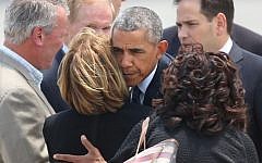 US President Barack Obama hugs Orange County Mayor Teresa Jacobs upon the president's arrival at Orlando International Airport, June 16, 2016, in Orlando, Florida. (Stephen M. Dowell/Orlando Sentinel via AP)