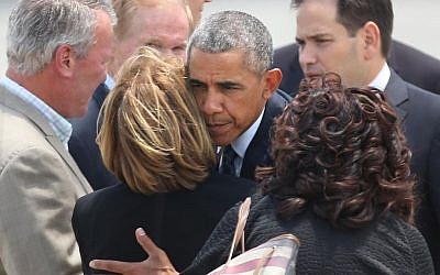 US President Barack Obama hugs Orange County Mayor Teresa Jacobs upon the president's arrival at Orlando International Airport, June 16, 2016, in Orlando, Florida. (Stephen M. Dowell/Orlando Sentinel via AP)