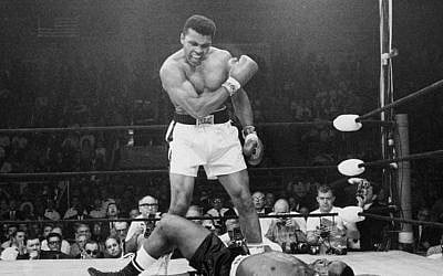 In this May 25, 1965, file photo, heavyweight champion Muhammad Ali, then known as Cassius Clay, stands over challenger Sonny Liston, shouting and gesturing shortly after dropping Liston with a short hard right to the jaw, in Lewiston, Maine. (AP Photo/John Rooney, File)