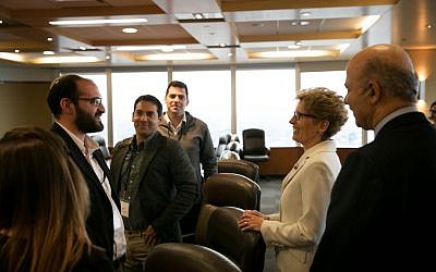 Canada's Premier of Ontario Kathleen Wynne and Ontario Minister of Research and Innovation Reza Moridi speak with The Time of Israel's Judah Ari Gross and other Israeli reporters in Toronto on May 2, 2016. (Nabil Shash/Government of Ontario)