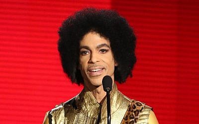 In this Nov. 22, 2015 file photo, Prince presents the award for favorite album - soul/R&B at the American Music Awards in Los Angeles. (Matt Sayles/Invision/AP)
