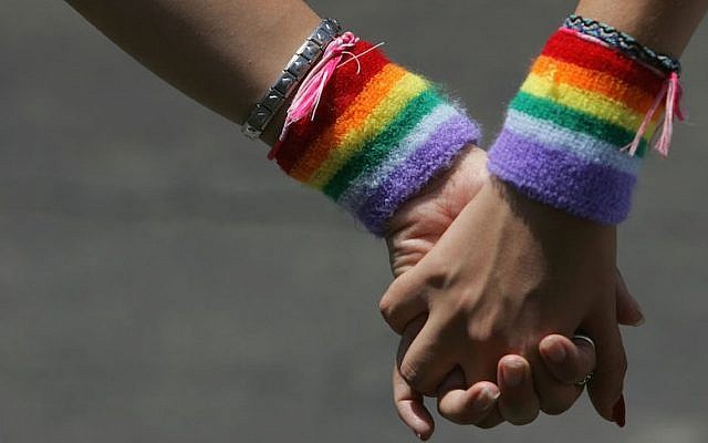 A lesbian couple hold hands during the Tel Aviv Gay Pride parade on June 3, 2016 (David Silverman/Getty Images via JTA, File) A lesbian couple hold hands during the Tel Aviv Gay Pride parade on June 3, 2016 (David Silverman/Getty Images via JTA, File)