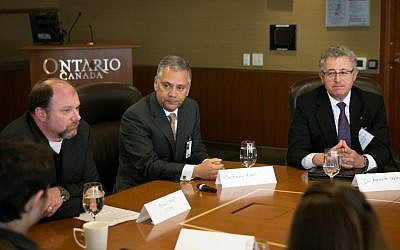 Michael May, left, Dr. Barry Rubin, center, and Kenneth Melvin, right, speaks to a group of Israeli journalists in Toronto on May 2, 2016. (Nabil Shash/Government of Ontario)