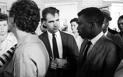 Writer Calvin Trillin, center, interviewing John Lewis in Birmingham, Alabama, as the Freedom Riders were boarding the bus for Montgomery in 1961. (LIFE Images Collection/via JTA)