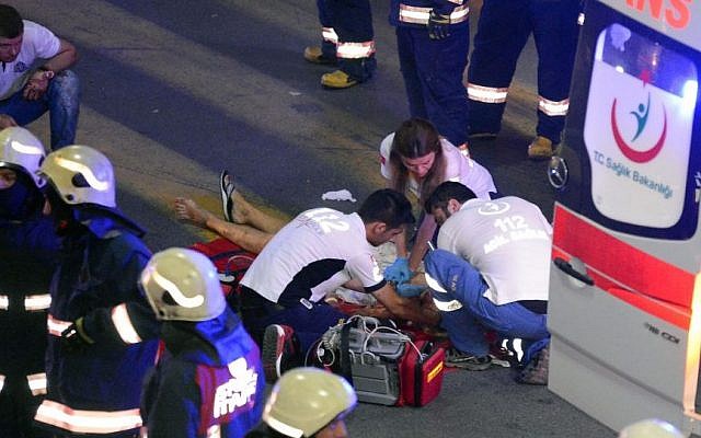 Turkish rescue services members help a wounded person outside Istanbul's Ataturk airport, Tuesday, June 28, 2016. (Ismail Coskun/IHA via AP) Turkish rescue services members help a wounded person outside Istanbul's Ataturk airport, Tuesday, June 28, 2016. (Ismail Coskun/IHA via AP)