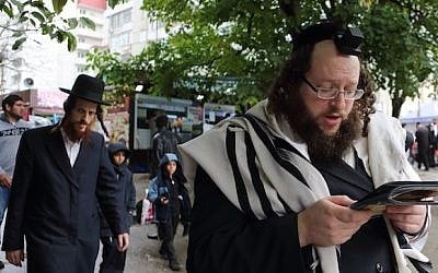 An illustrative photo of ultra-Orthodox Jewish men praying on the eve of Rosh Hashanah in Uman, Ukraine (Yaakov Naumi/Flash90) 