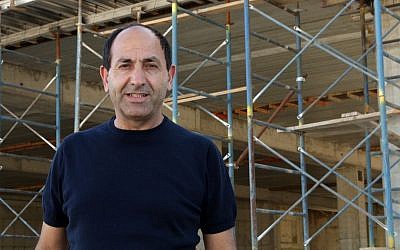 Rami Levy at the construction site for his new mall in Atarot, Jerusalem, June 21, 2016. ( Luke tress/Times of Israel)