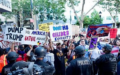 Police form a line to contain protesters outside a campaign rally for Republican presidential candidate Donald Trump on Thursday, June 2, 2016, in San Jose, Calif.  (AP Photo/Noah Berger)