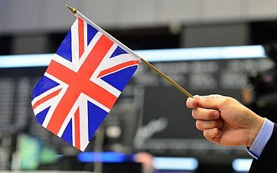 A man poses with a Great Britain flag a day after a majority of the British population voted to leave the European Union on June 24, 2016 in Frankfurt, Germany. (Thomas Lohnes/Getty Images/JTA)