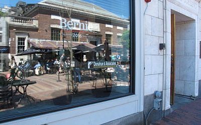In this June 10, 2016, photo, Church Street is reflected in the window of the building where Sen. Bernie Sanders' campaign headquarters is located in Burlington, Vt. (AP Photo/Wilson Ring)