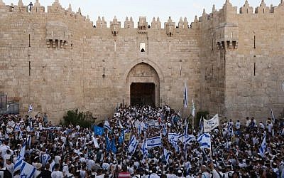 Illustrative: Thousands of Israeli wave the national flag as they celebrate Jerusalem Day, dancing and marching their way through Damascus Gate to the Western Wall, in the Old City of Jerusalem, May 17, 2015. (Yonatan Sindel/Flash90)