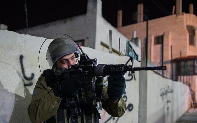 Illustrative: An Israeli soldier during an operation near Bethlehem in the West Bank on December 8, 2015. (Nati Shohat/Flash90) Illustrative: An Israeli soldier during an operation near Bethlehem in the West Bank on December 8, 2015. (Nati Shohat/Flash90)