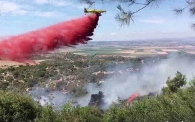 Firefighters fighting a blaze near the Megiddo Junction in northern Israel on June 11, 2016. (Screen capture: Facebook) Firefighters fighting a blaze near the Megiddo Junction in northern Israel on June 11, 2016. (Screen capture: Facebook)