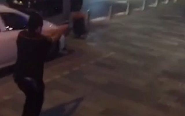 A still from a video captured by a passerby with a phone shows security guard A. in pursuit of a terrorist at Tel Aviv's Sarona Market on Wednesday, June 8, 2016. (Screen capture Ynet) A still from a video captured by a passerby with a phone shows security guard A. in pursuit of a terrorist at Tel Aviv's Sarona Market on Wednesday, June 8, 2016. (Screen capture Ynet)