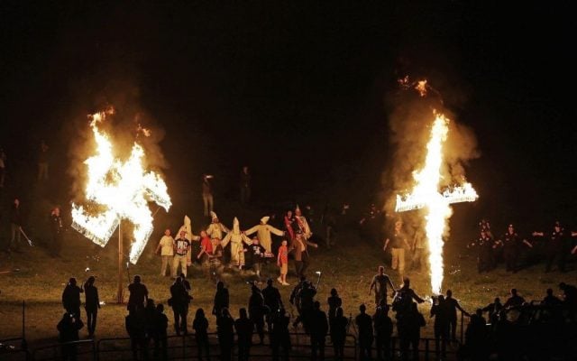 In this Saturday, April 23, 2016 photo, members of the Ku Klux Klan participate in cross and swastika burnings after a 'white pride' rally in rural Paulding County near Cedar Town, Georgia. (AP Photo/Mike Stewart) In this Saturday, April 23, 2016 photo, members of the Ku Klux Klan participate in cross and swastika burnings after a 'white pride' rally in rural Paulding County near Cedar Town, Georgia. (AP Photo/Mike Stewart)