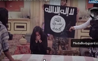 Heba Magdi, an Egyptian actress, cowers in fear as TV pranksters  dressed up as Islamic State terrorists stage a mock kidnap, June 2016    Screenshot)