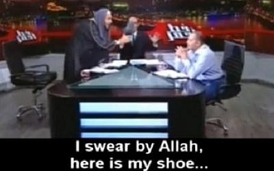 A Muslim cleric threatens to beat an Egyptian astrologer with his shoe in this clip from a May 27, 2016 TV show (screen capture: MEMRI) A Muslim cleric threatens to beat an Egyptian astrologer with his shoe in this clip from a May 27, 2016 TV show (screen capture: MEMRI)
