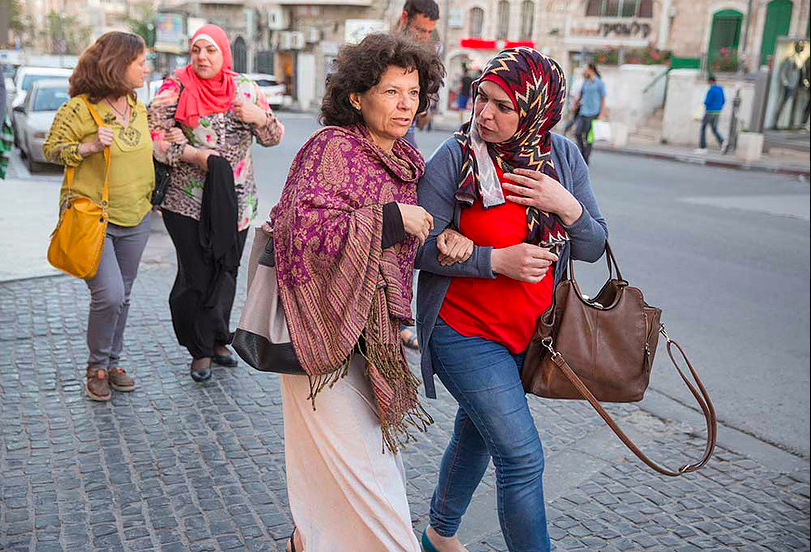 Annie Kurland and a fellow teacher walking through Jerusalem's Mahane Yehuda market in 2016, as part of the Teachers' Room coexistence project (Courtesy Dana Talel) Annie Kurland and a fellow teacher walking through Jerusalem's Mahane Yehuda market in 2016, as part of the Teachers' Room coexistence project (Courtesy Dana Talel)