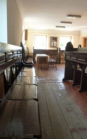 The waiting area in the ancient synagogue, where many of Chernivtsi's Christians and others from around the world wait to ask Rabbi Noah Kofmansky to intervene on their behalf with the Jewish God. (Julie Masis/Times of Israel)