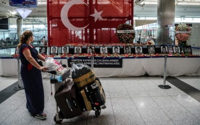 Two days after a triple suicide bombing, a passenger looks at the pictures of killed airport employees at Ataturk airport international terminal in Istanbul on June 30, 2016. (AFP/OZAN KOSE/) Two days after a triple suicide bombing, a passenger looks at the pictures of killed airport employees at Ataturk airport international terminal in Istanbul on June 30, 2016. (AFP/OZAN KOSE/)
