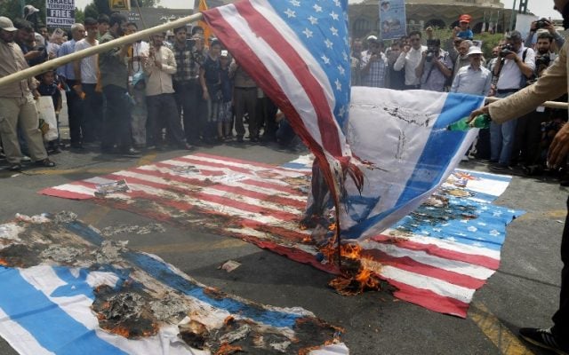 Illustrative. Iranian protestors set US and Israeli flags afire during a parade marking al-Quds (Jerusalem) Day in Tehran on July 1, 2016. (AFP/Atta Kenare) Illustrative. Iranian protestors set US and Israeli flags afire during a parade marking al-Quds (Jerusalem) Day in Tehran on July 1, 2016. (AFP/Atta Kenare)