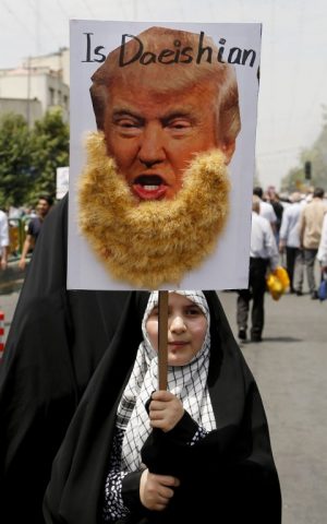 An Iranian girl holds up a portrait of US Republican presidential candidate Donald Trump adorned with jihadist-style beard and a slogan reading "is Daeishian" (Daesh is Arabic acronym for Islamic State), during a parade marking al-Quds (Jerusalem) Day in Tehran on July 01, 2016. (Atta Kenare/AFP) An Iranian girl holds up a portrait of US Republican presidential candidate Donald Trump adorned with jihadist-style beard and a slogan reading "is Daeishian" (Daesh is Arabic acronym for Islamic State), during a parade marking al-Quds (Jerusalem) Day in Tehran on July 01, 2016. (Atta Kenare/AFP)