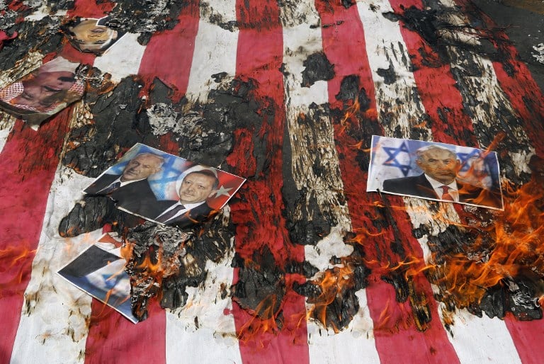Portraits of Bahraini King Hamad (top L), Prime Minister Benjamin Netanyahu and Turkish President Recep Tayyip Erdogan lie on a US flag in flames during a parade marking al-Quds (Jerusalem) Day in Tehran on July 01, 2016. (Atta Kenare/AFP) Portraits of Bahraini King Hamad (top L), Prime Minister Benjamin Netanyahu and Turkish President Recep Tayyip Erdogan lie on a US flag in flames during a parade marking al-Quds (Jerusalem) Day in Tehran on July 01, 2016. (Atta Kenare/AFP)