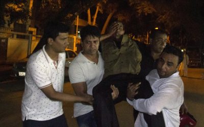 People carry an injured man near the Holey Artisan Bakery restaurant during an attack by unidentified gunmen in Dhaka's high-security diplomatic district on July 2, 2016. (AFP Photo/STR) People carry an injured man near the Holey Artisan Bakery restaurant during an attack by unidentified gunmen in Dhaka's high-security diplomatic district on July 2, 2016. (AFP Photo/STR)