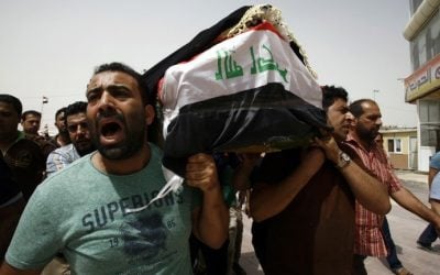 Iraqi men carry a coffin in the holy Iraqi city of Najaf during a funeral procession for the victims of a suicide bombing that ripped through Baghdad's busy shopping district of Karrada on July 3, 2016. (AFP/Haidar HAMDANI)