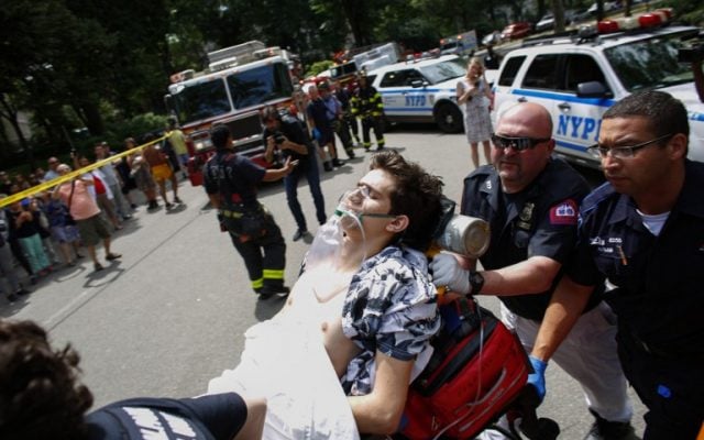 A critically injured man lies on a stretcher after an explosion at Central Park in New York on July 3, 2016. The New York Police Department (NYPD) said one person was injured. No further details were immediately available. (AFP PHOTO / KENA BETANCUR)