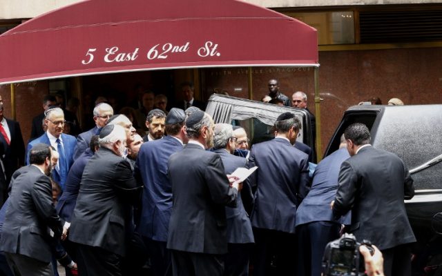 The casket for Nobel laureate and Holocaust survivor Elie Wiesel is placed into a hearse outside the Fifth Avenue Synagogue on July 3, 2016 in New York. (AFP PHOTO / KENA BETANCUR)