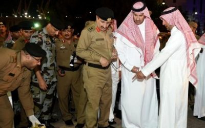 Saudi Emir of Medina Faisal bin Salman bin Abdulaziz (2R) and security officers look at blood stains on the ground after a suicide attack near the security headquarters outside one of Islam's holiest sites, the Prophet's Mosque in Medina on July 4, 2016. (AFP PHOTO / STR)