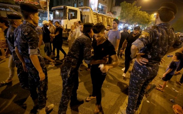 Iraqi security forces keep watch on on July 5, 2016 at the site of a suicide car bomb attack which took place early on July 3 in Baghdad's Karrada neighborhood. (AFP /AHMAD AL-RUBAYE)