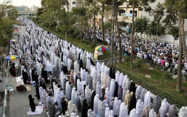 Iranian Muslims perform Eid al-Fitr prayers in western Tehran on July 06, 2016. (AFP/ATTA KENARE)