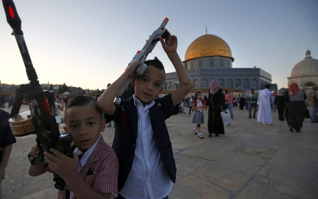 Palestinian boys hold toy guns on the Temple Mount during Eid al-Fitr on July 6, 2016.(AFP PHOTO / AHMAD GHARABLI)