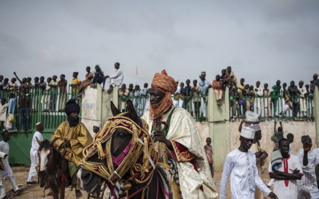 A man on horseback waits outside the Kofar Mata Eid Ground to join the Emir of Kano's procession during the Durbar procession in Kano, northern Nigeria on July 6, 2016. Kano is Nigeria's largest Muslim city and celebrates Eid al-Fitr with the Durbar festival, an event that sees a parade of the Emir and his entourage go through the streets of the city on horseback accompanied by musicians.  (AFP PHOTO / STEFAN HEUNIS)