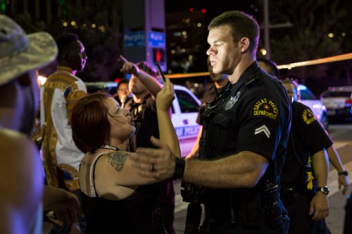 Police attempt to calm the crowd as someone is arrested following the sniper shooting in Dallas on July 7, 2016. (AFP PHOTO / Laura Buckman) Police attempt to calm the crowd as someone is arrested following the sniper shooting in Dallas on July 7, 2016. (AFP PHOTO / Laura Buckman)