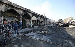 Iraqi policemen inspect the aftermath scene of a mortar and bombing attack on the Sayyid Mohammed shrine in the Balad area, located 70 kilometers (around 45 miles) north of Baghdad, on July 8, 2016. (AFP/Ahmad al-Rubaye)