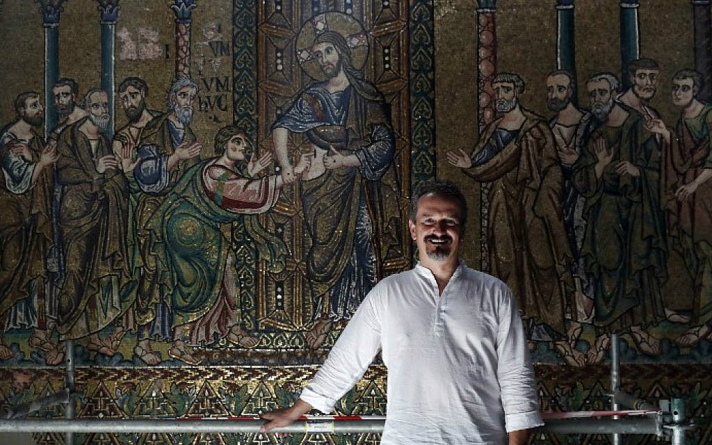 Giammarco Piacenti, CEO of the Piacenti restoration company, poses in front of a renovated mosaic wall inside the Church of the Nativity in the biblical West Bank town of Bethlehem on July 8, 2016. (Thomas Coex/AFP) Giammarco Piacenti, CEO of the Piacenti restoration company, poses in front of a renovated mosaic wall inside the Church of the Nativity in the biblical West Bank town of Bethlehem on July 8, 2016. (Thomas Coex/AFP)