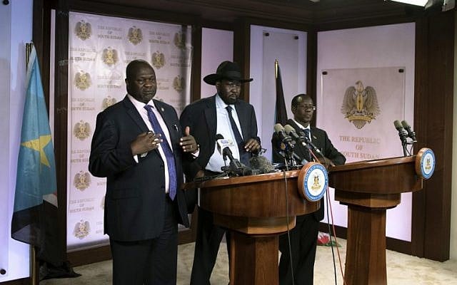 First Vice President Riek Machar (L) delivers a speech to journalists next to South Sudan President Salva Kiir (C) and Vice President James Wani Igga (R) prior to the shooting outside the presidential palace in Juba on July 8, 2016. (AFP PHOTO/Charles Atiki Lomodong)