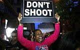 A woman holds a banner during a protest in support of the Black Lives Matter movement in New York on July 09, 2016. (AFP Photo/Kena Betancur)