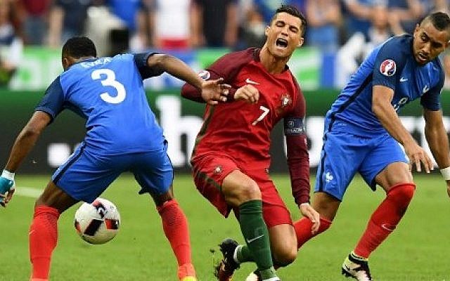 France's forward Dimitri Payet (R) looks on as Portugal's forward Cristiano Ronaldo falls onto the pitch during the Euro 2016 final football match between France and Portugal at the Stade de France in Saint-Denis, north of Paris, on July 10, 2016. (AFP PHOTO / FRANCK FIFE) France's forward Dimitri Payet (R) looks on as Portugal's forward Cristiano Ronaldo falls onto the pitch during the Euro 2016 final football match between France and Portugal at the Stade de France in Saint-Denis, north of Paris, on July 10, 2016. (AFP PHOTO / FRANCK FIFE)