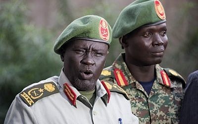 Former Sudan People's Liberation Army (SPLA) chief of general training and former in-opposition general Dau Athorjang (L) speaks during a press conference, pledging his allegiance to the SPLA on July 10, 2016 in Juba. (AFP PHOTO/CHARLES ATIKI LOMODONG)