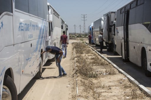 Buses received on the Palestinian side of the Israeli border terminal of Erez in the Gaza strip in the first such delivery since Israeli imposed a blockade on Gaza in 2007, seen here on July 13, 2016. (AFP/MAHMUD HAMS)