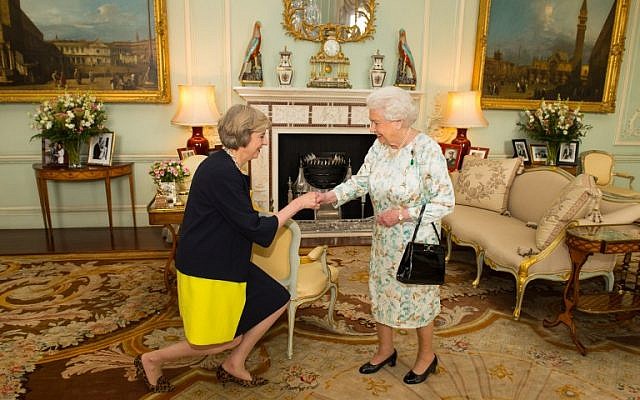 The new leader of the Conservative Party Theresa May, left, is greeted by Britain's Queen Elizabeth II in Buckingham Palace on July 13, 2016 where the queen invited the former home secretary to become prime minister and form a new government. (AFP/ POOL / Dominic Lipinski)