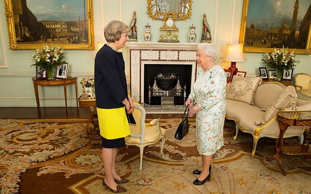 The new leader of the Conservative Party Theresa May, left, is greeted by Britain's Queen Elizabeth II in Buckingham Palace on July 13, 2016 where the queen invited the former home secretary to become prime minister and form a new government. (AFP/ POOL / Dominic Lipinski)