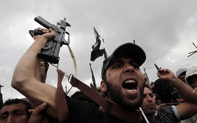  Sunni gunmen chanting slogans and brandishing their weapons during the funeral of Sheikh Ahmad Abdel Wahed and his religious companion in their hometown al-Bireh, north of Beirut. May 21, 2012 (AFP PHOTO / JOSEPH EID)