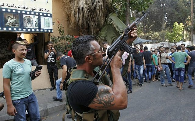 A Lebanese gunman during the funeral procession of Hamad al-Moqdad, one of the Lebanese victims of a car bomb attack that killed dozens in a Beirut stronghold of terror group Hezbollah on August 16, 2013.(AFP PHOTO / ANWAR AMRO ) A Lebanese gunman during the funeral procession of Hamad al-Moqdad, one of the Lebanese victims of a car bomb attack that killed dozens in a Beirut stronghold of terror group Hezbollah on August 16, 2013.(AFP PHOTO / ANWAR AMRO )